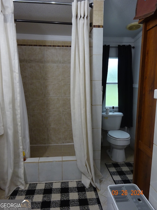 bathroom with tile patterned flooring, walk in shower, and toilet