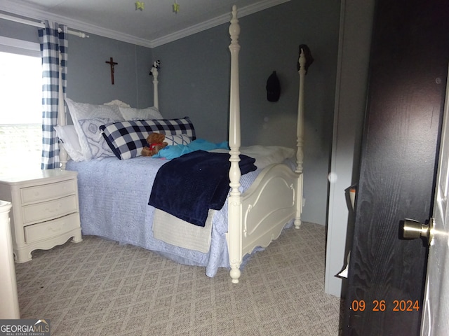 bedroom with ornamental molding and light carpet