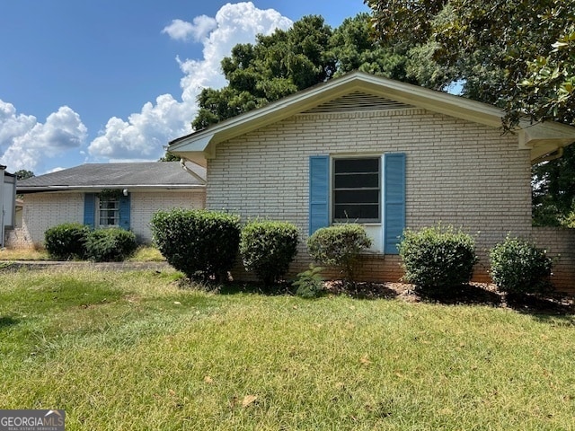 view of home's exterior with a lawn