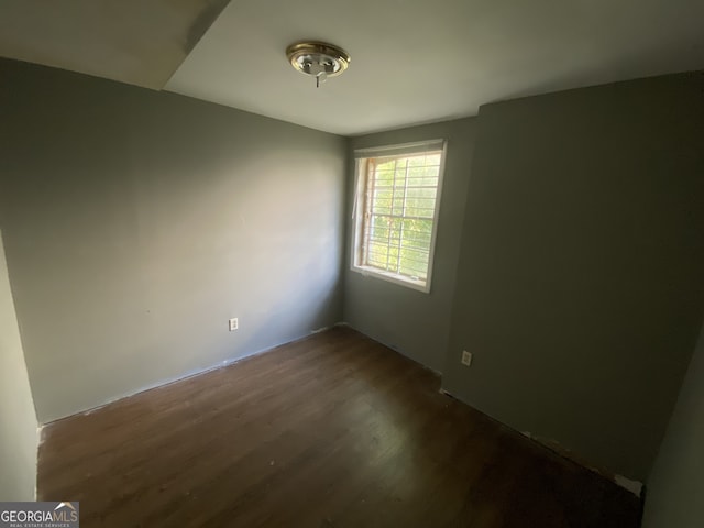 unfurnished room featuring dark hardwood / wood-style flooring