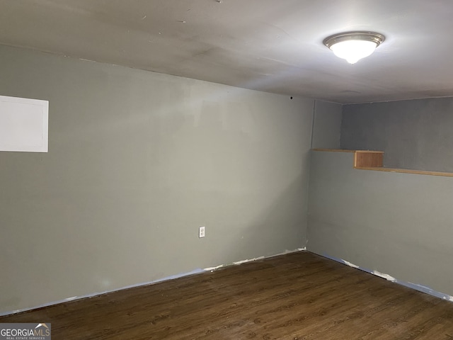 unfurnished room with dark hardwood / wood-style floors