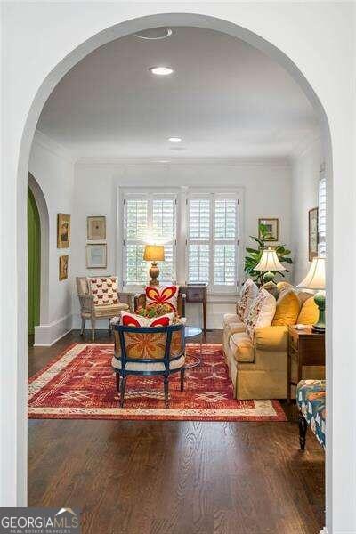 sitting room with crown molding and hardwood / wood-style floors