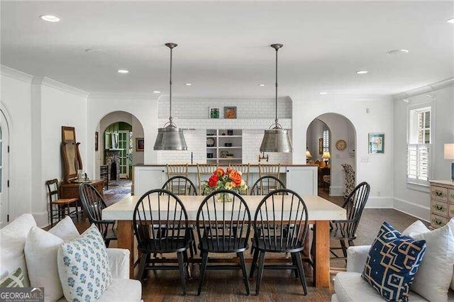 dining room featuring crown molding and dark wood-type flooring