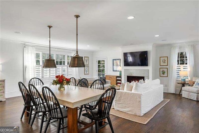 dining room featuring crown molding and dark hardwood / wood-style floors