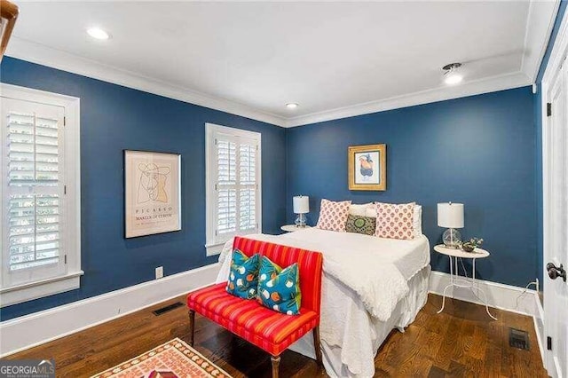 bedroom with wood-type flooring and crown molding