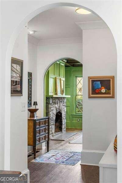 corridor featuring hardwood / wood-style flooring and crown molding