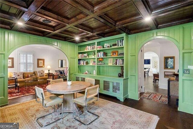 dining room with dark wood-type flooring and coffered ceiling