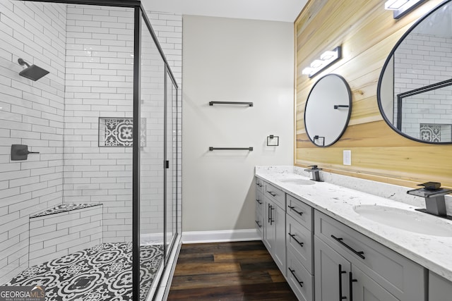 bathroom featuring vanity, a shower with shower door, and hardwood / wood-style flooring