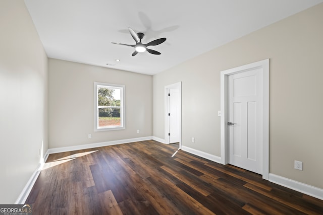 unfurnished bedroom featuring dark wood-type flooring and ceiling fan