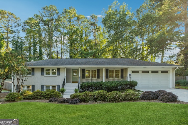 view of front of property with a garage, a front lawn, and a porch