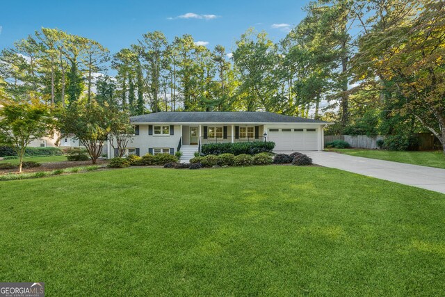 view of front facade with a garage, a porch, and a front lawn