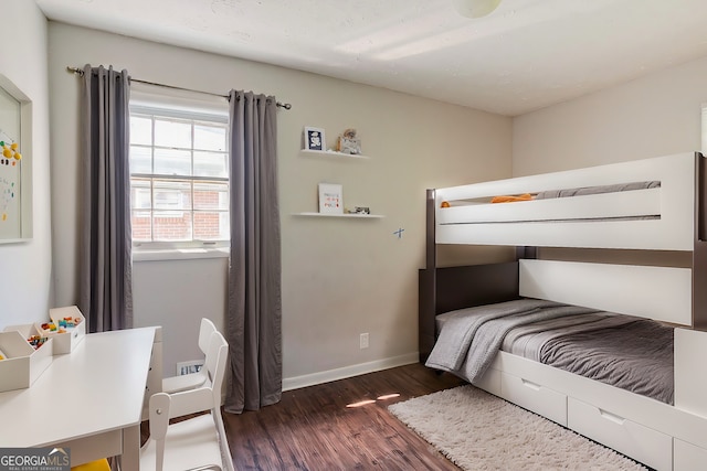 bedroom with dark hardwood / wood-style flooring