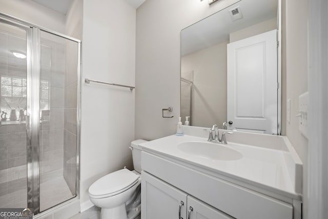 bathroom featuring a shower with door, vanity, and toilet