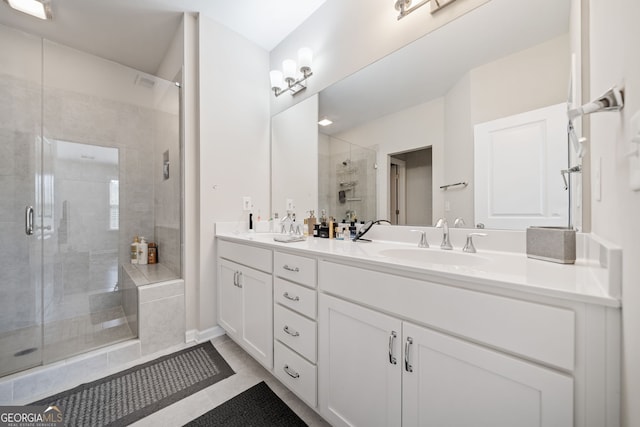 bathroom with tile patterned flooring, a shower with door, and vanity