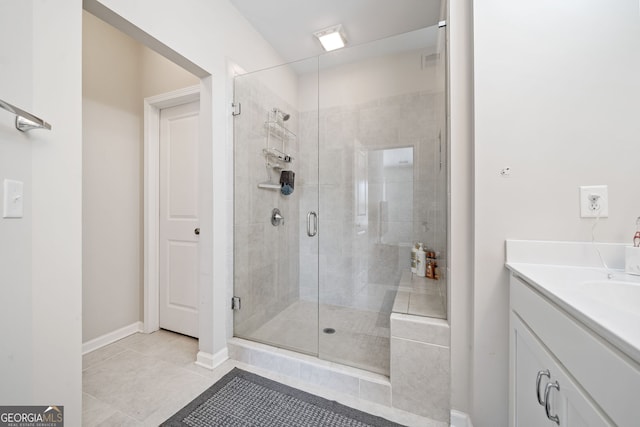 bathroom with vanity, tile patterned flooring, and an enclosed shower