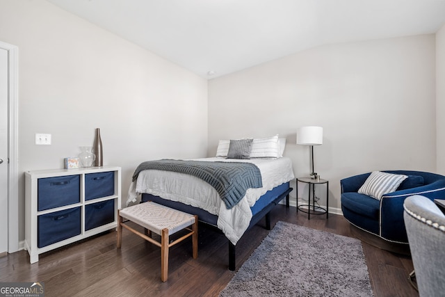 bedroom featuring lofted ceiling and dark hardwood / wood-style flooring