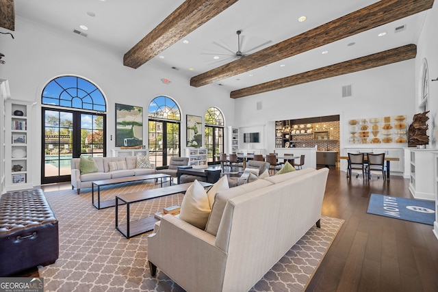 living room featuring ceiling fan, beam ceiling, french doors, dark hardwood / wood-style floors, and a high ceiling