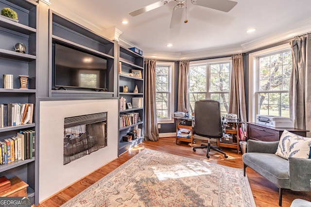 office space with hardwood / wood-style floors, ceiling fan, and crown molding