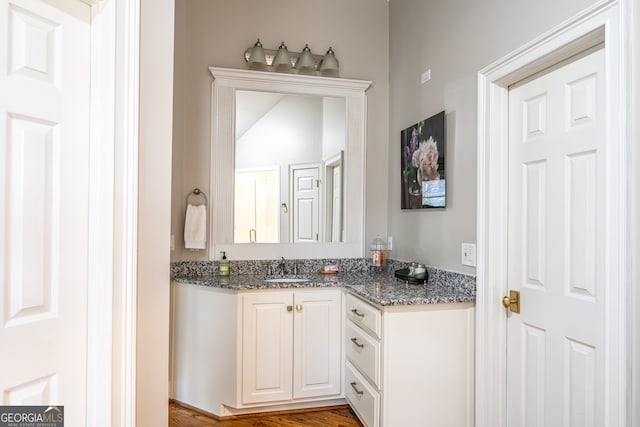 bathroom with hardwood / wood-style flooring and vanity