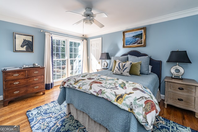 bedroom with ceiling fan, crown molding, and light wood-type flooring