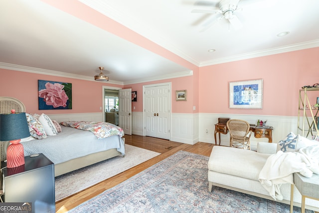 bedroom with ceiling fan, crown molding, and wood-type flooring