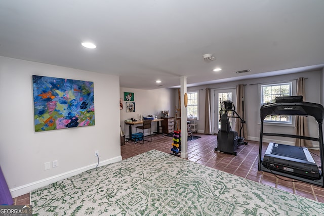 workout area featuring dark tile patterned flooring