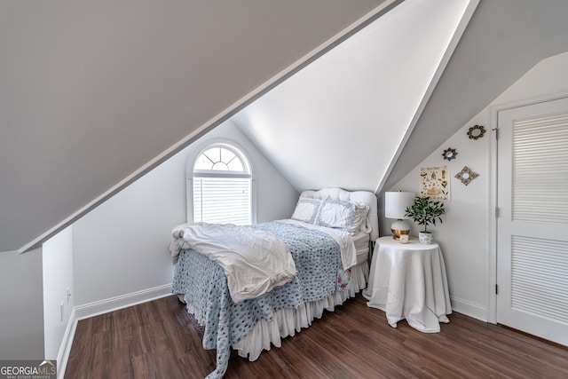 bedroom featuring dark hardwood / wood-style floors and vaulted ceiling