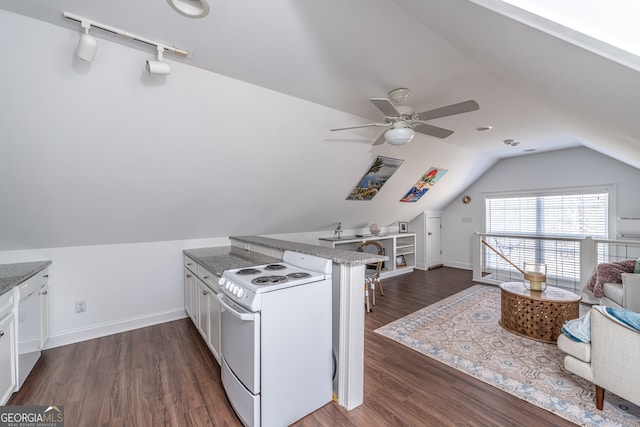 kitchen with white range with electric cooktop, white cabinets, dark wood-type flooring, and lofted ceiling