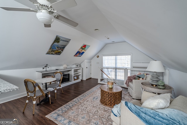 living room featuring dark hardwood / wood-style floors, ceiling fan, and lofted ceiling