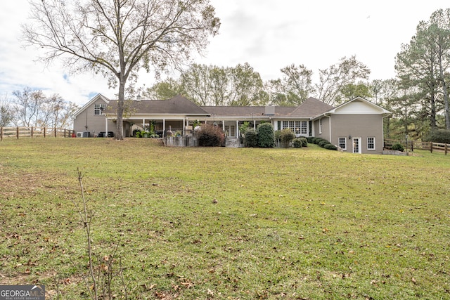 rear view of house with a yard