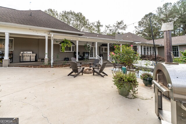 view of patio featuring area for grilling and a fire pit