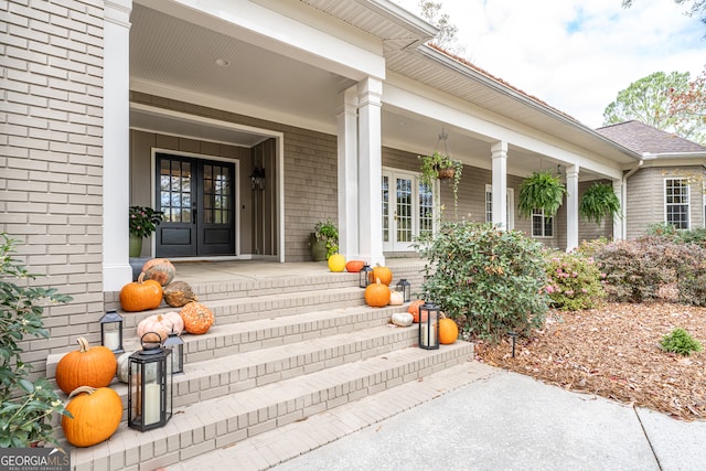 view of exterior entry featuring a porch