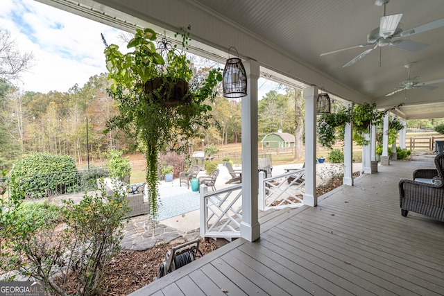 wooden deck featuring outdoor lounge area and ceiling fan