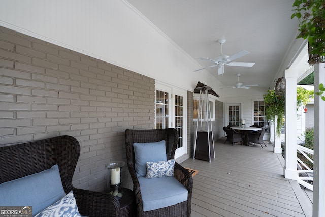 wooden deck featuring ceiling fan