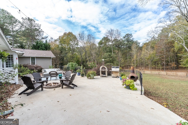 view of patio with a grill and an outdoor fire pit