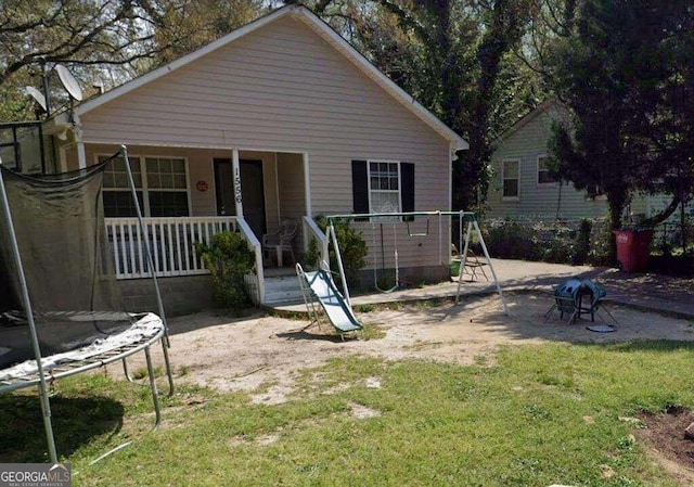 1556 Wellworth Ave, Macon, GA 31204 - view of front of home featuring a trampoline, a front yard, and a porch