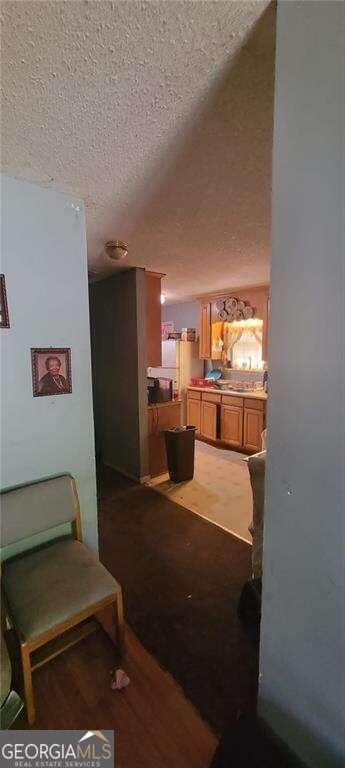 hallway with a textured ceiling