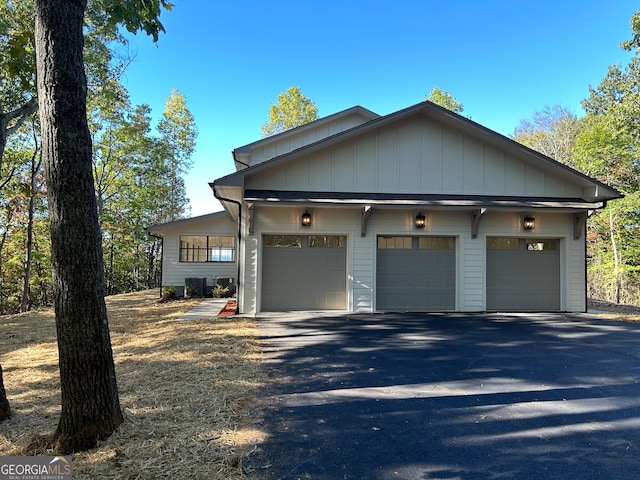 view of front of home with a garage and cooling unit