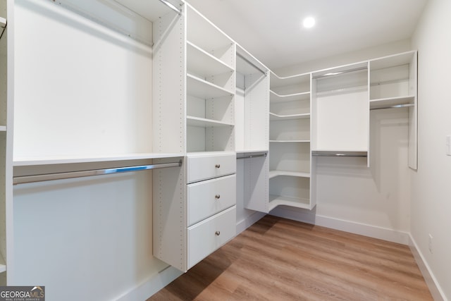 spacious closet with light hardwood / wood-style floors