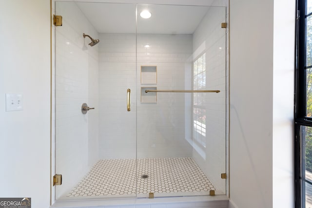 bathroom featuring a shower with shower door