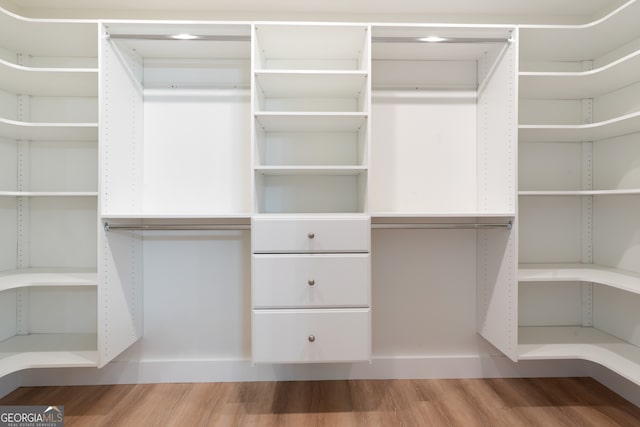 walk in closet featuring hardwood / wood-style flooring