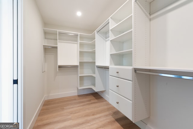 spacious closet featuring light hardwood / wood-style floors