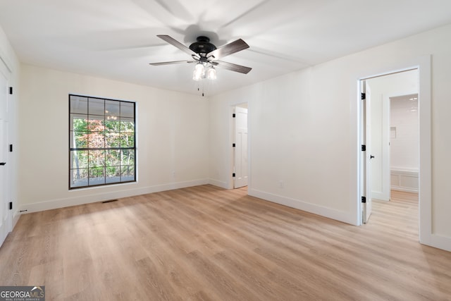 unfurnished room with light wood-type flooring and ceiling fan