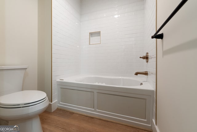 bathroom with toilet, shower with separate bathtub, and hardwood / wood-style floors