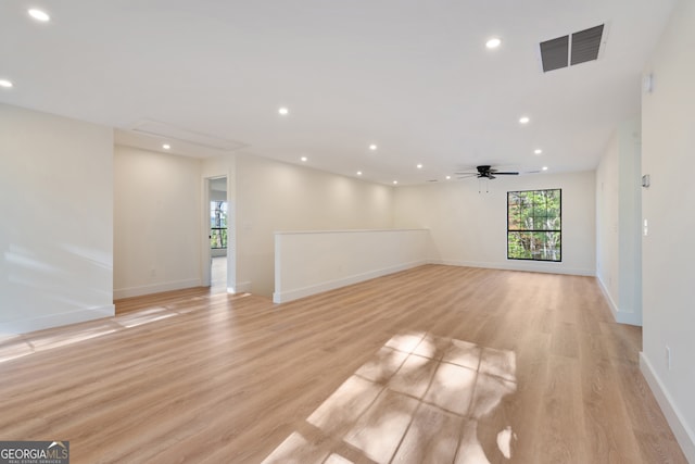 unfurnished room with light wood-type flooring and ceiling fan