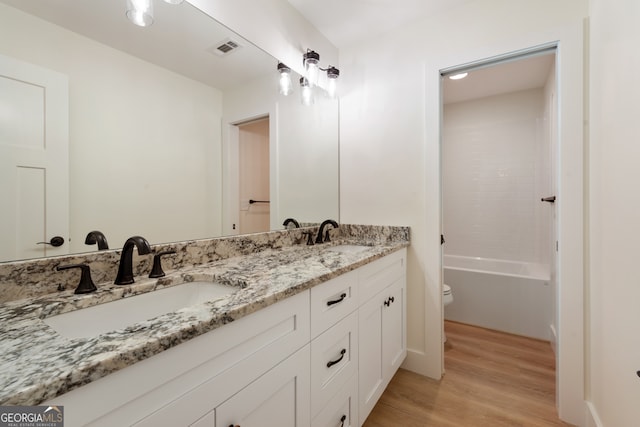 bathroom with vanity, hardwood / wood-style flooring, and toilet