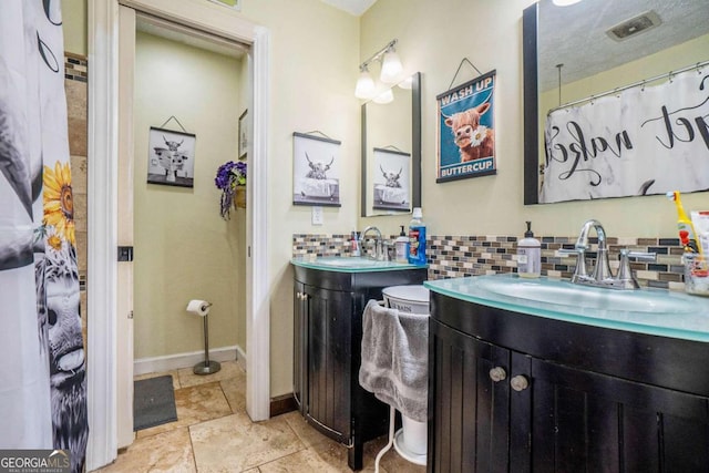 bathroom featuring vanity and backsplash