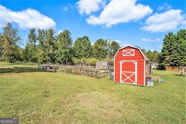 view of outdoor structure featuring a yard and a rural view