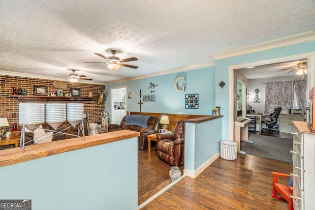 living room with plenty of natural light, dark hardwood / wood-style floors, and a textured ceiling