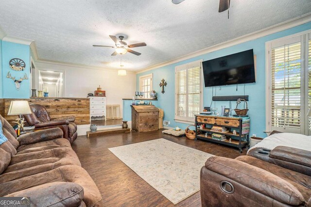 living room featuring ornamental molding, dark hardwood / wood-style flooring, and ceiling fan